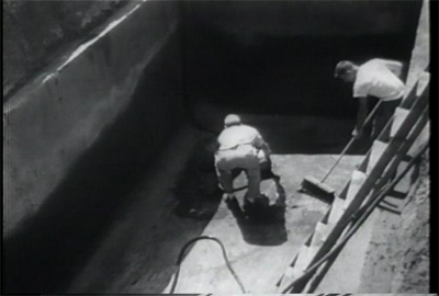 The men prepare the concrete vault