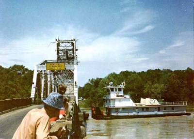 Curious onlookers peer over the bridge as they see what happens