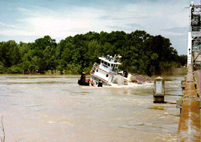 The boat is nearly completely out of the water on the other side of the bridge